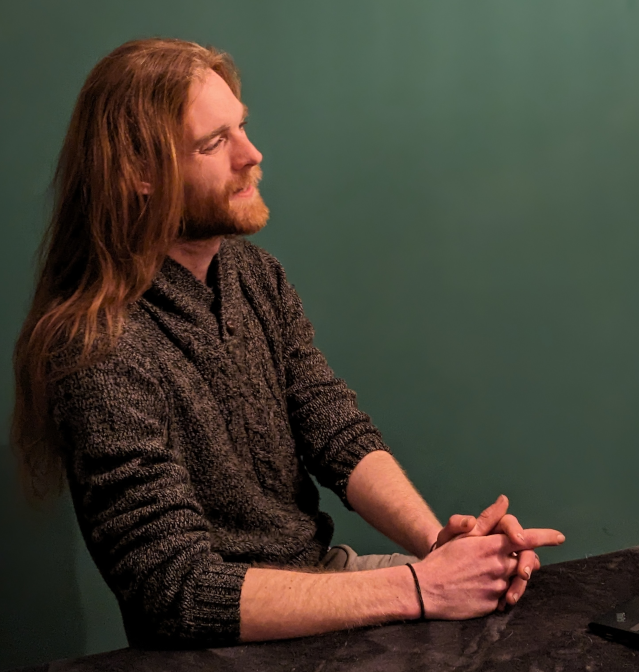 Profile Picture of Adrián Moreno (@zetxek), working side by side with a colleague: sitting on a desk, while looking at a screen